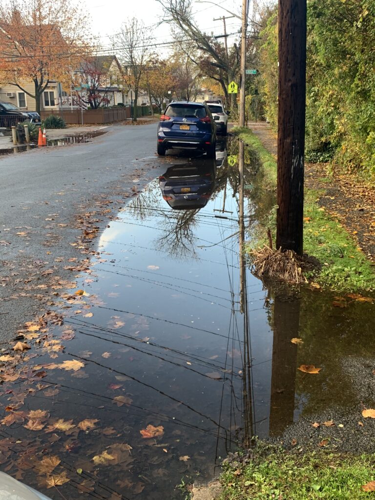 a flooded street with cars parked on the side (MyCoast AI)