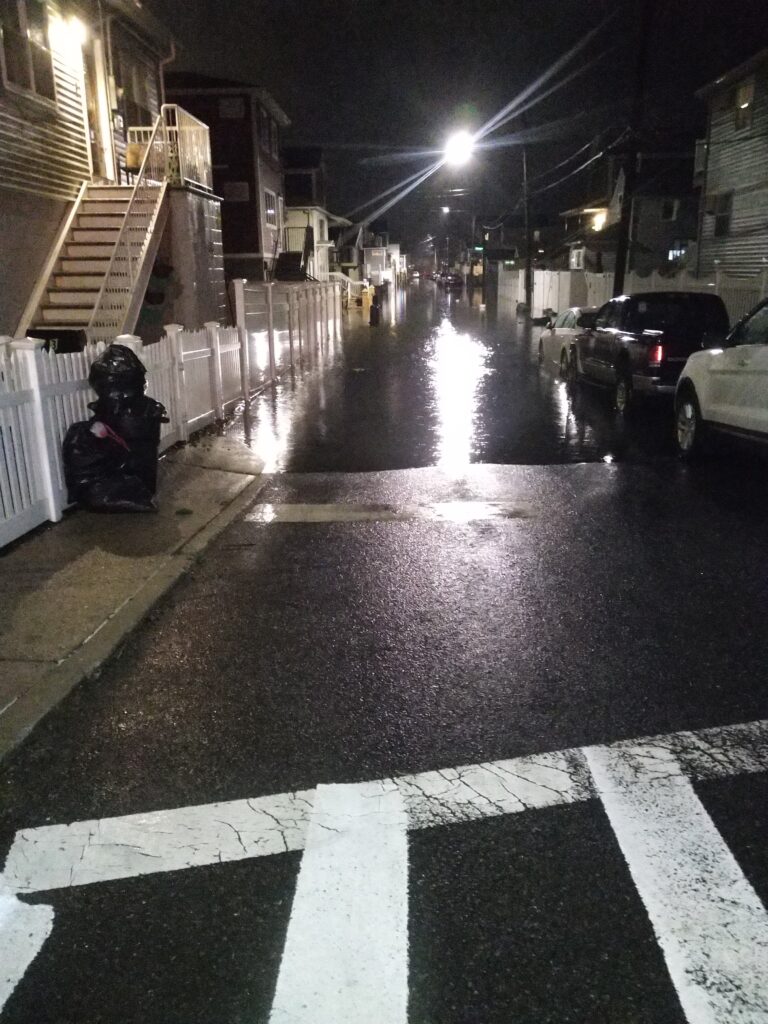a street with cars and a motorcycle parked on the side (MyCoast AI)