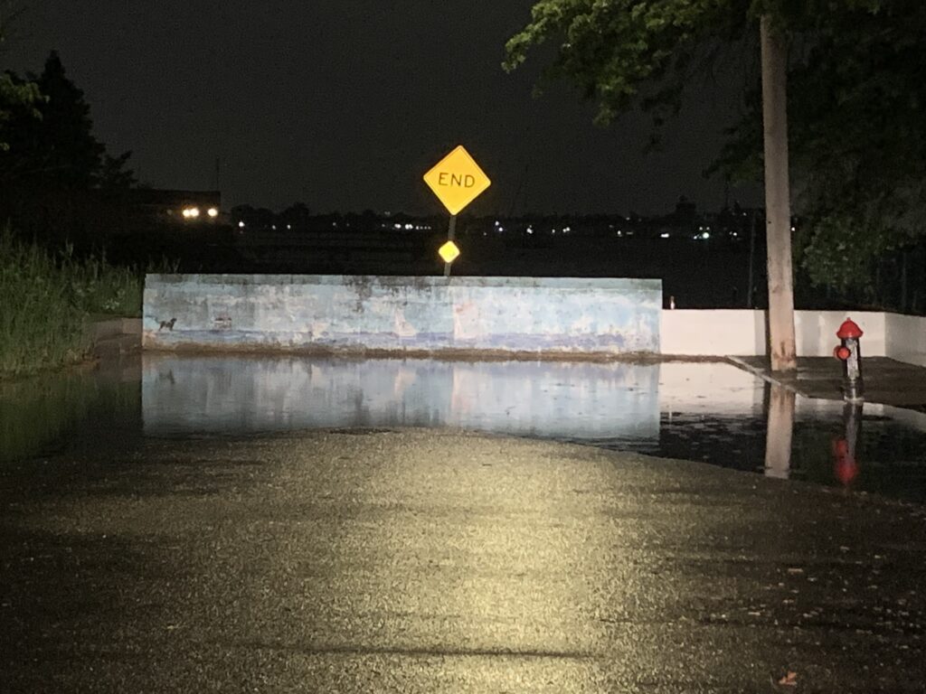 a concrete fountain with a sign (MyCoast AI)
