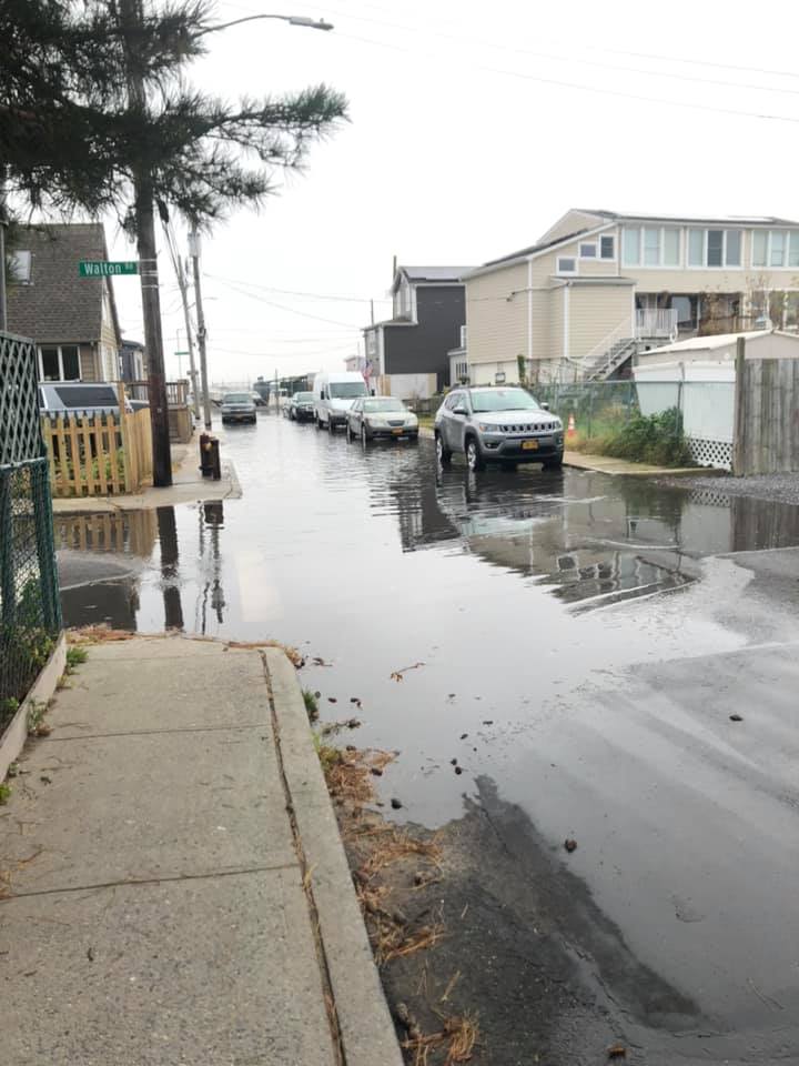 a flooded street with cars parked on the side (MyCoast AI)