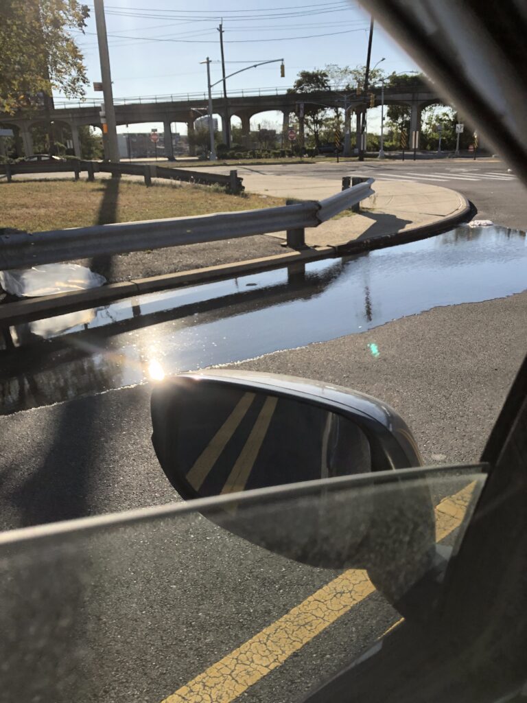 a puddle on a road (MyCoast AI)