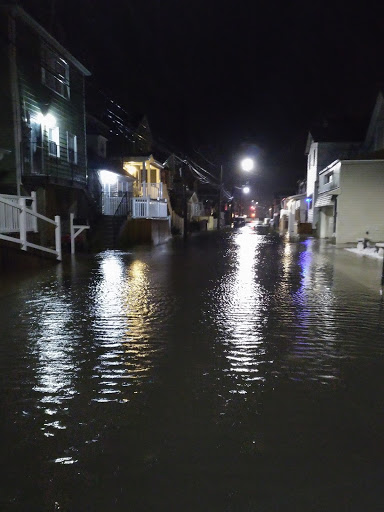 a body of water with buildings along it at night (MyCoast AI)
