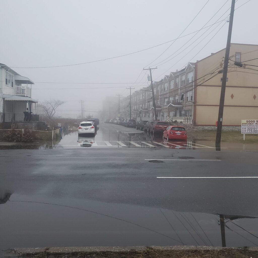 a street with cars on it and buildings on the side (MyCoast AI)