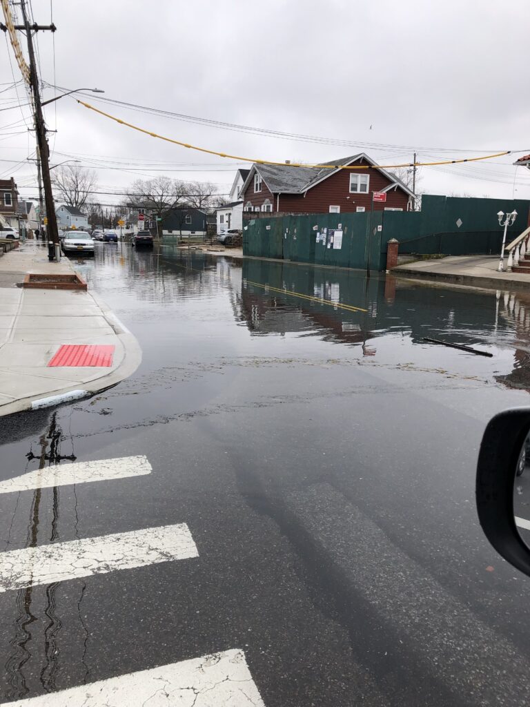 a flooded street with buildings and cars (MyCoast AI)