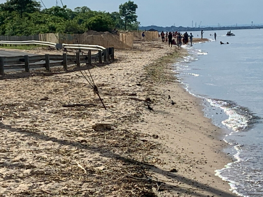 a beach with people and a fence (MyCoast AI)