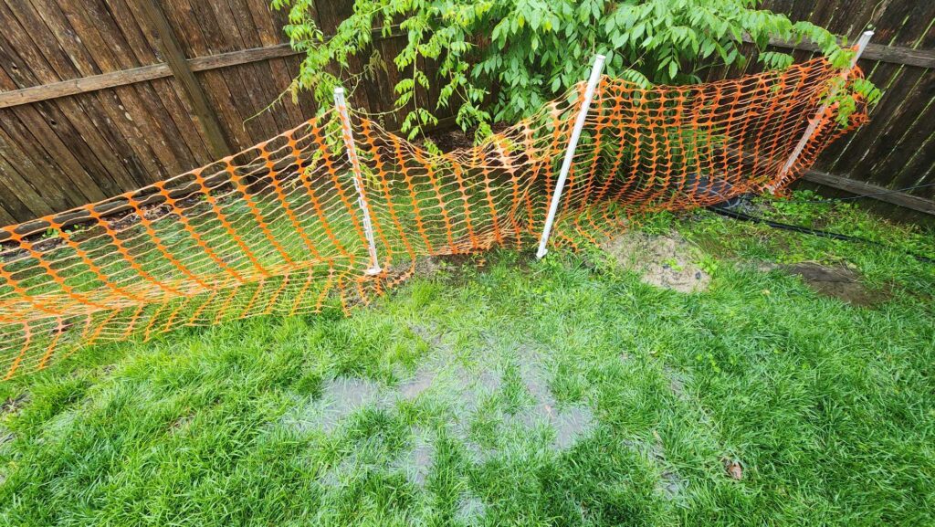 a fenced in yard with a red and yellow net (MyCoast AI)