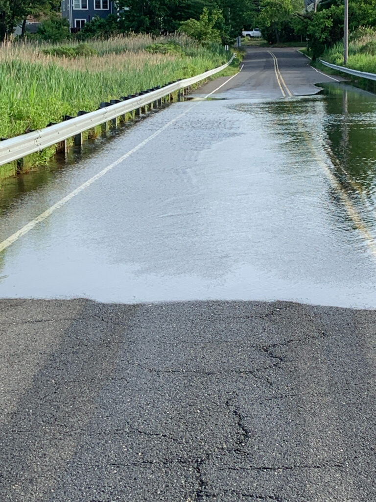 a flooded road with a yellow line (MyCoast AI)