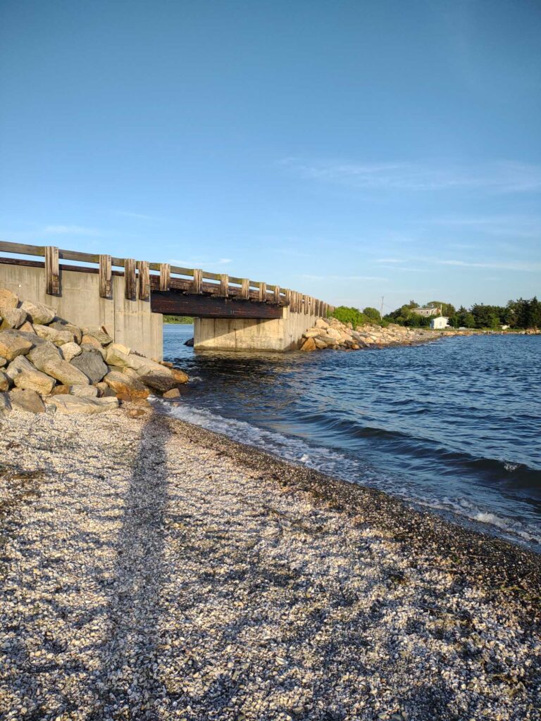 a beach with a bridge over it (MyCoast AI)