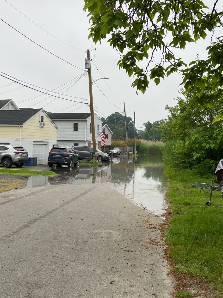 a flooded street with cars parked on the side (MyCoast AI)