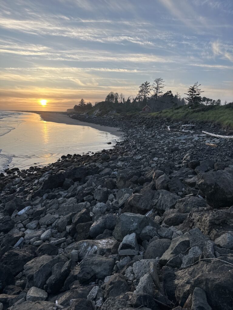 a rocky beach with a sunset (MyCoast AI)