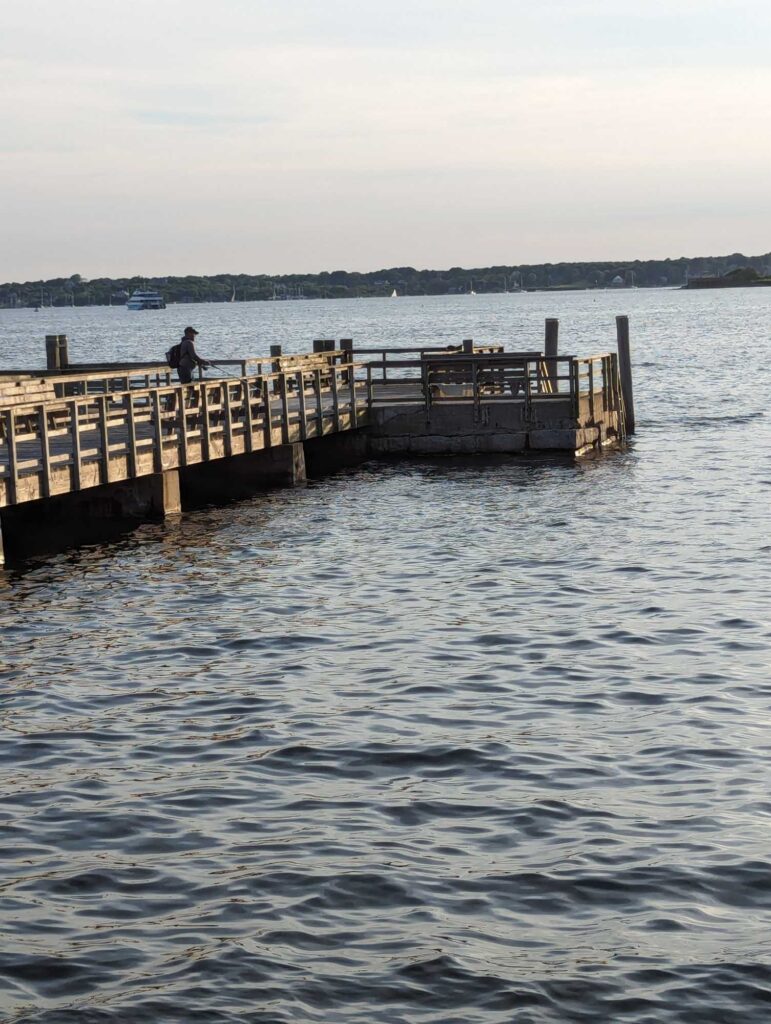 a person sitting on a dock (MyCoast AI)