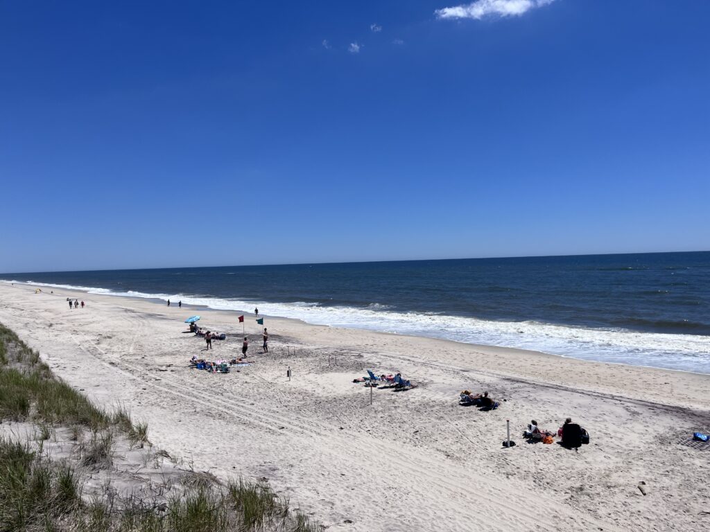 a beach with people and blue sky (MyCoast AI)