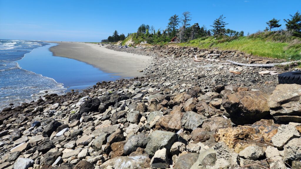 a rocky beach with a body of water in the background (MyCoast AI)