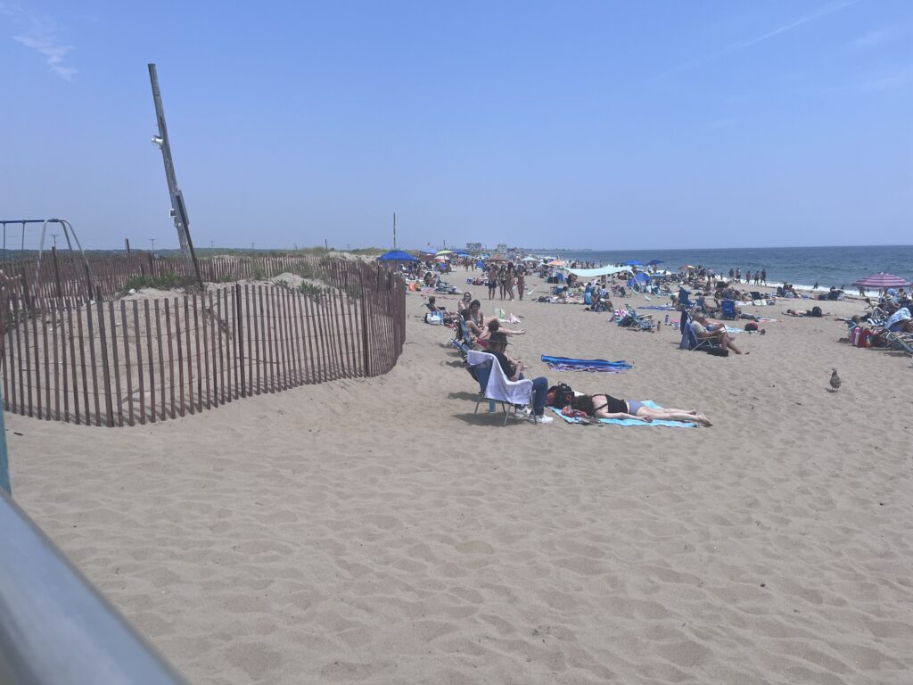 a group of people sitting on a beach (MyCoast AI)