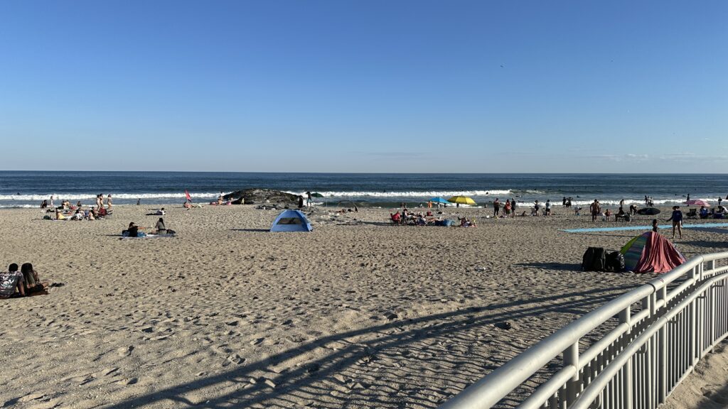 a beach with people and tents (MyCoast AI)