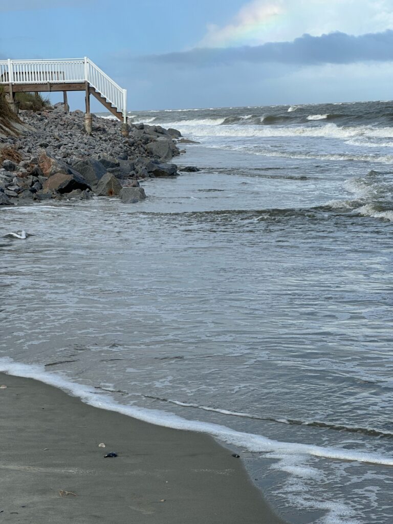 a beach with rocks and a pier (MyCoast AI)