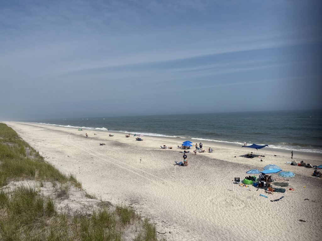 a beach with people and umbrellas (MyCoast AI)