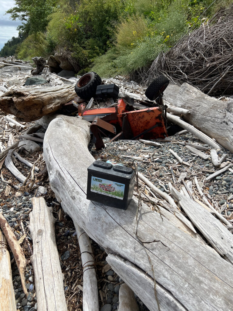 a pile of wood and a device (MyCoast AI)