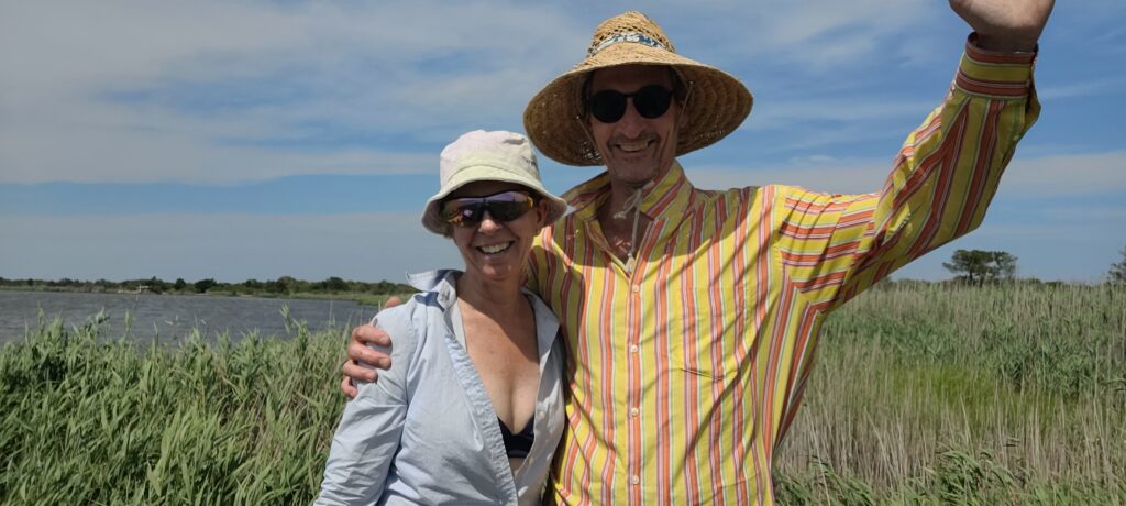a man and woman wearing hats and standing in a field (MyCoast AI)