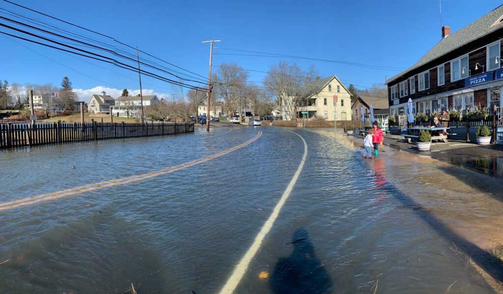 a flooded street with people walking on it (MyCoast AI)