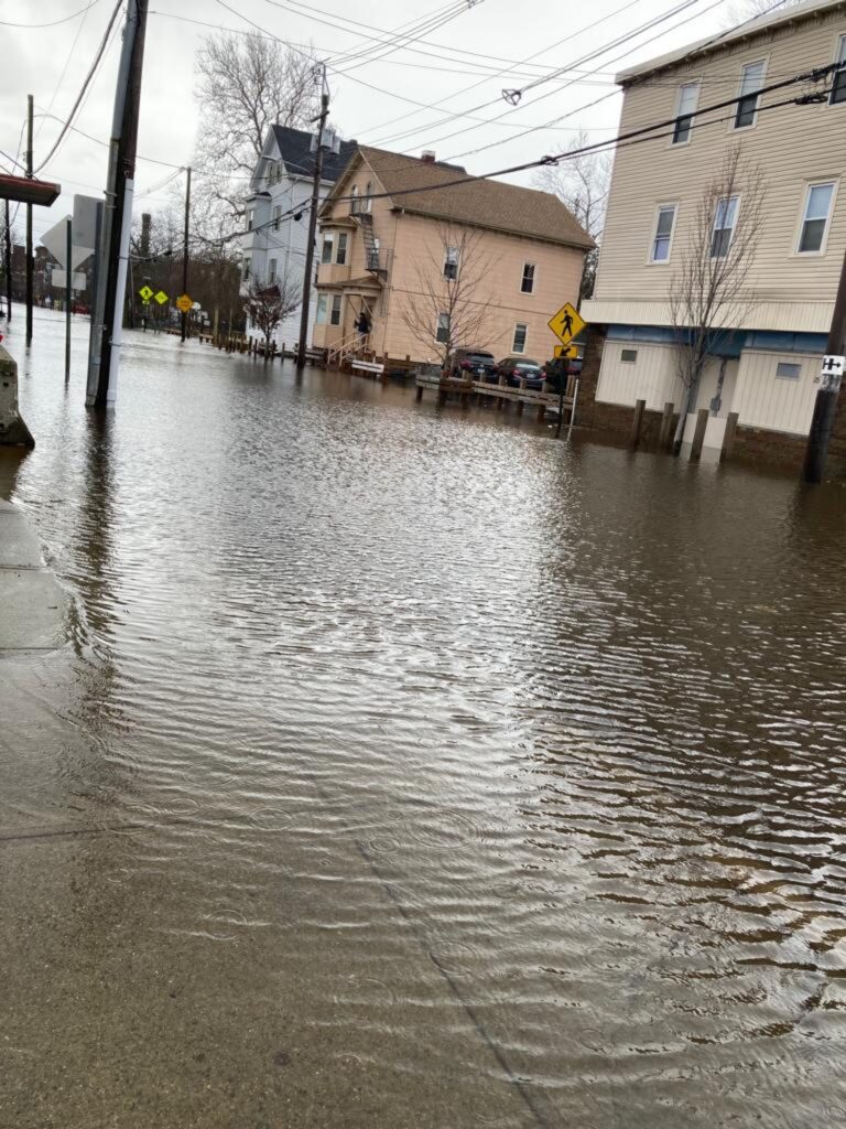 a flooded street with buildings on either side of it (MyCoast AI)