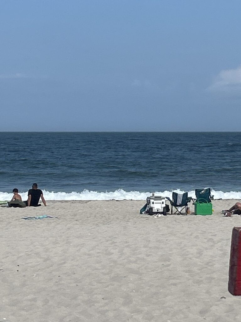 people sitting on a beach (MyCoast AI)