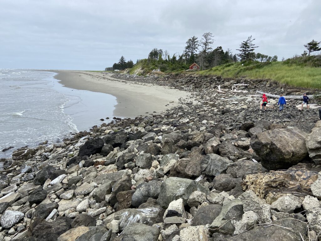 a rocky beach with people walking on it (MyCoast AI)