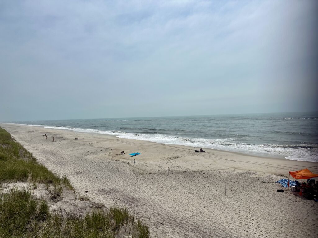 a beach with people and umbrellas (MyCoast AI)