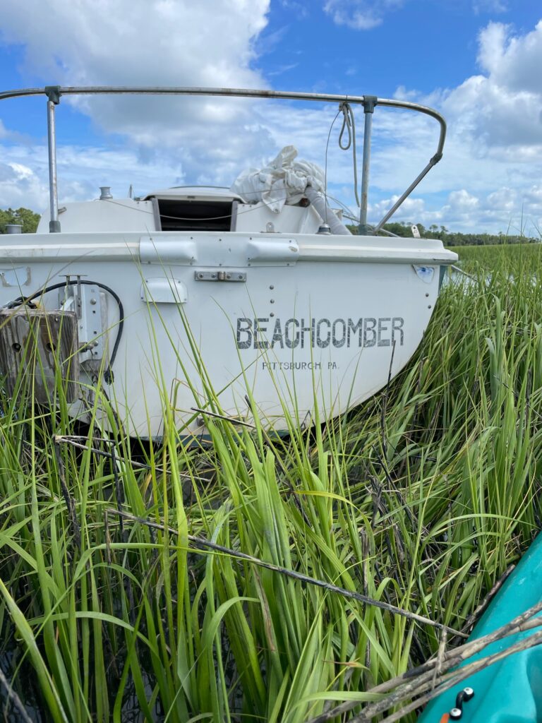 a white boat in a field (MyCoast AI)