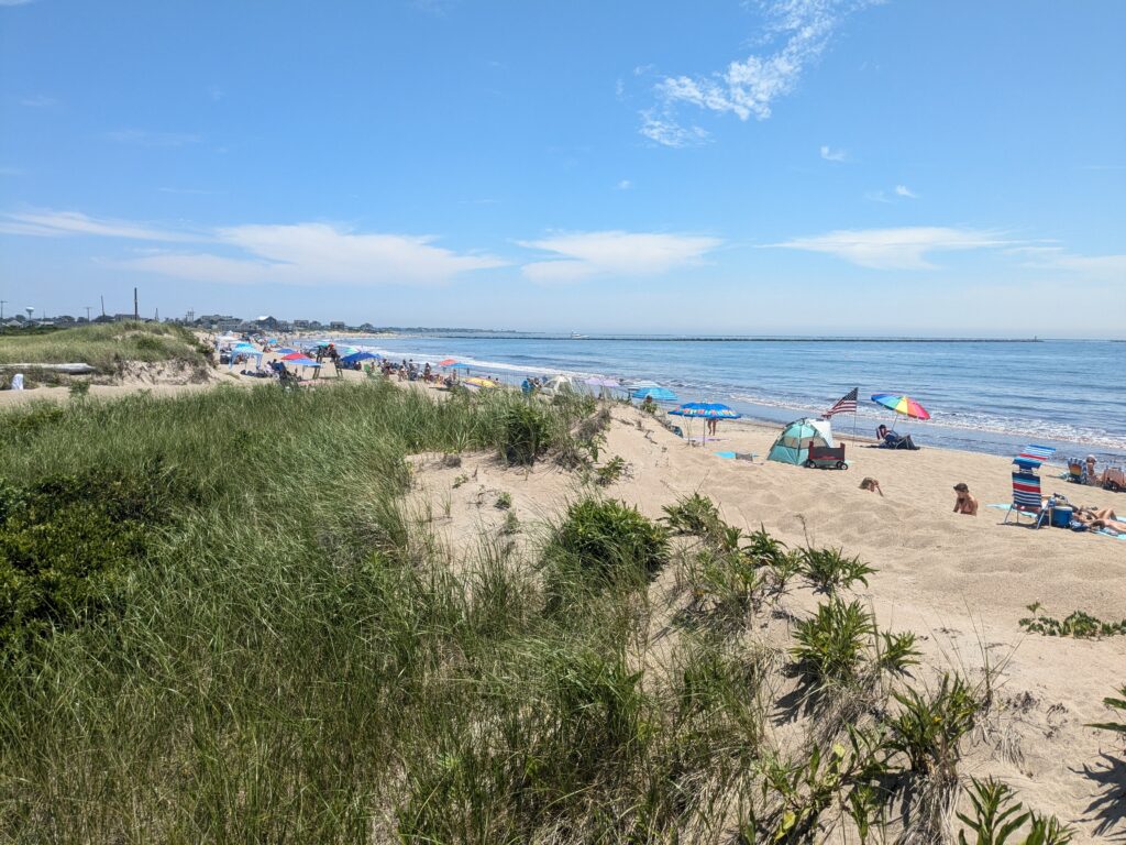 a beach with people and umbrellas (MyCoast AI)