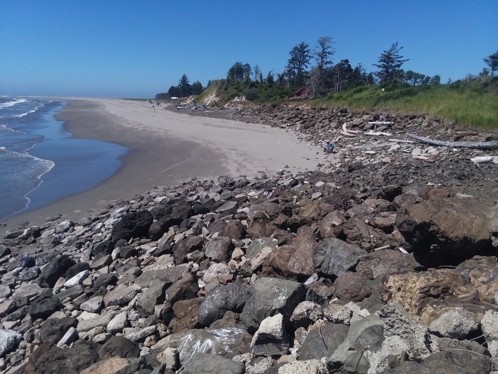 a rocky beach with a body of water in the background (MyCoast AI)