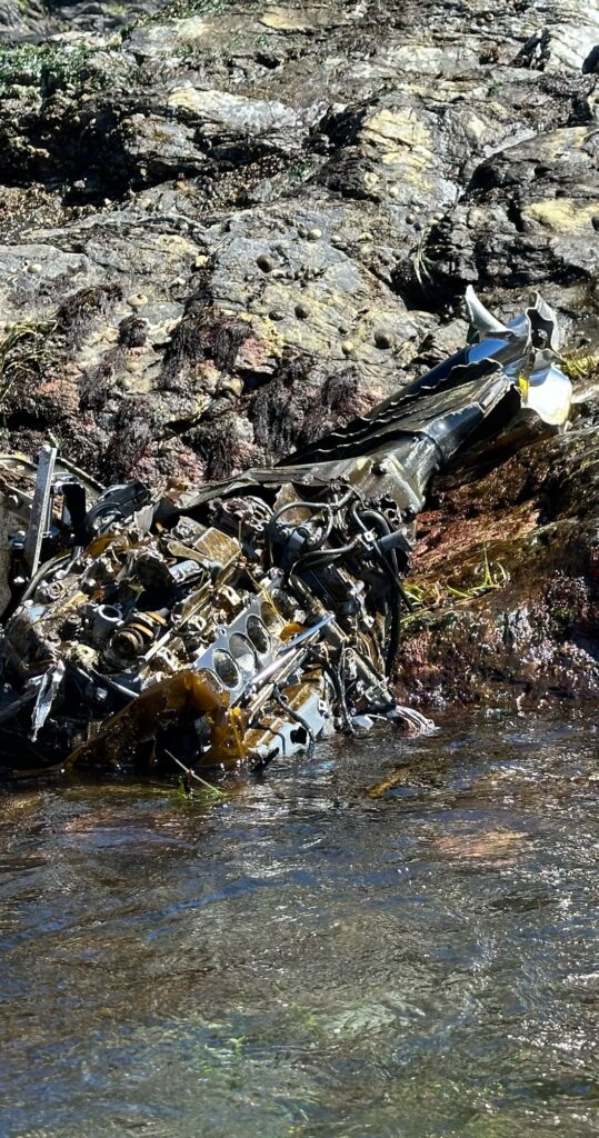 a pile of garbage next to a river (MyCoast AI)