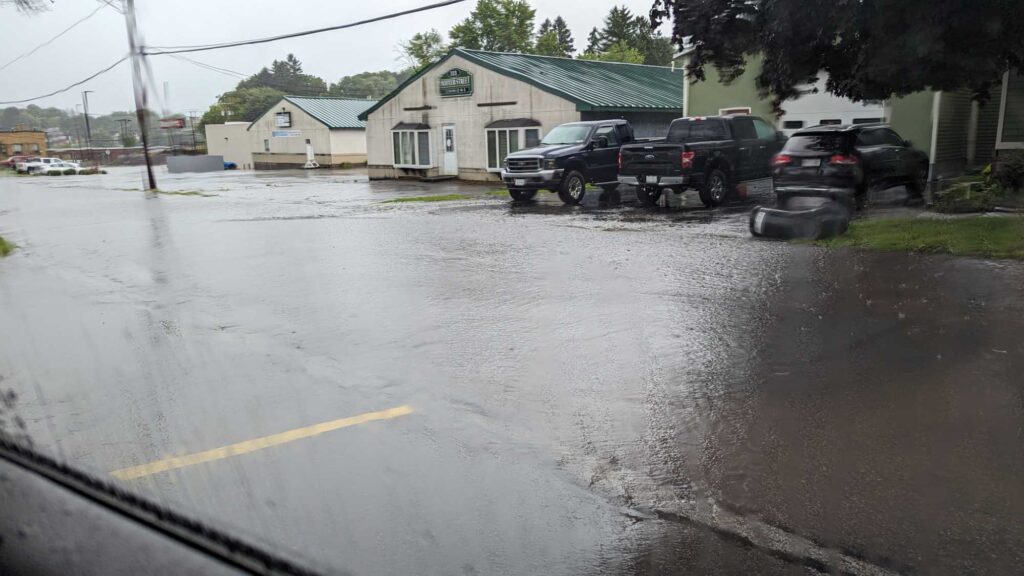 a flooded street with cars parked on the side (MyCoast AI)