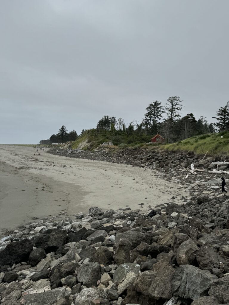 a rocky beach with a red house (MyCoast AI)