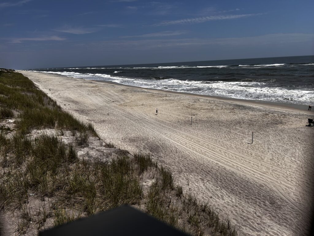 a sandy beach with waves crashing on it (MyCoast AI)
