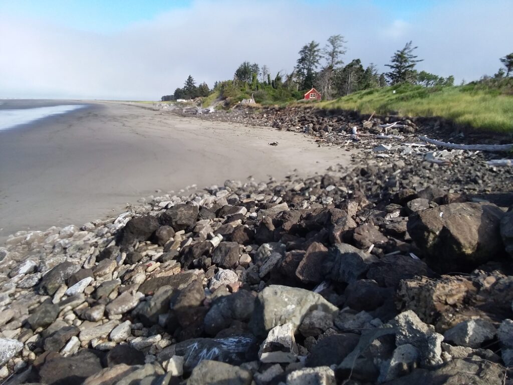 a rocky beach with a red tent (MyCoast AI)