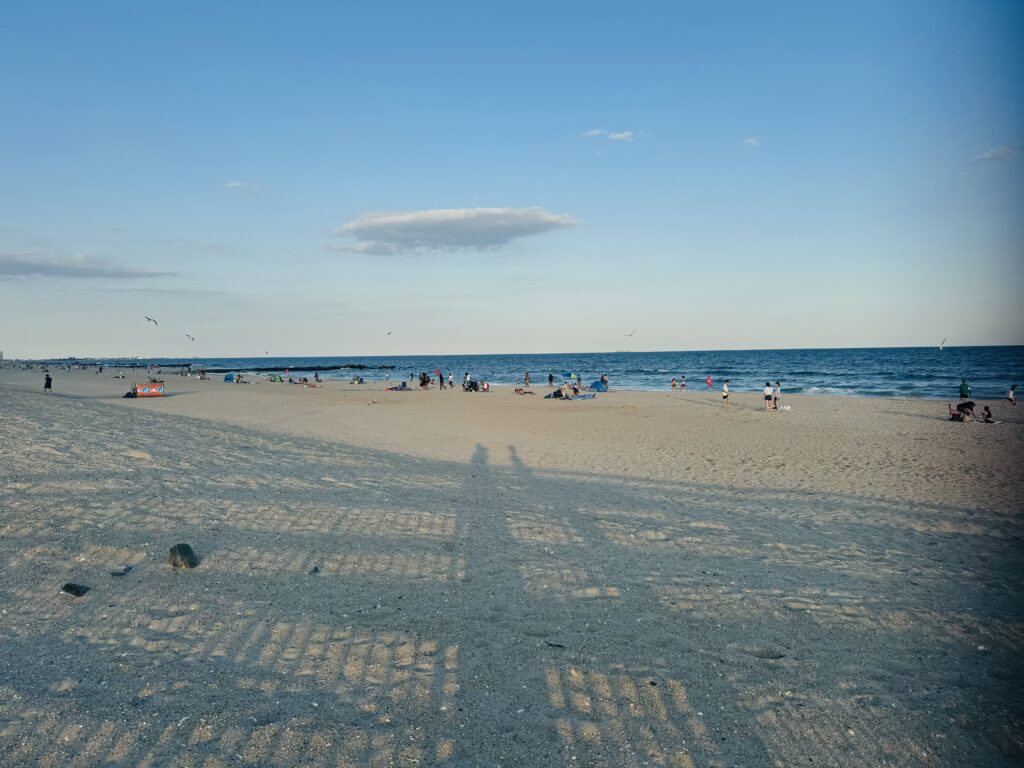 a beach with people and water in the background (MyCoast AI)