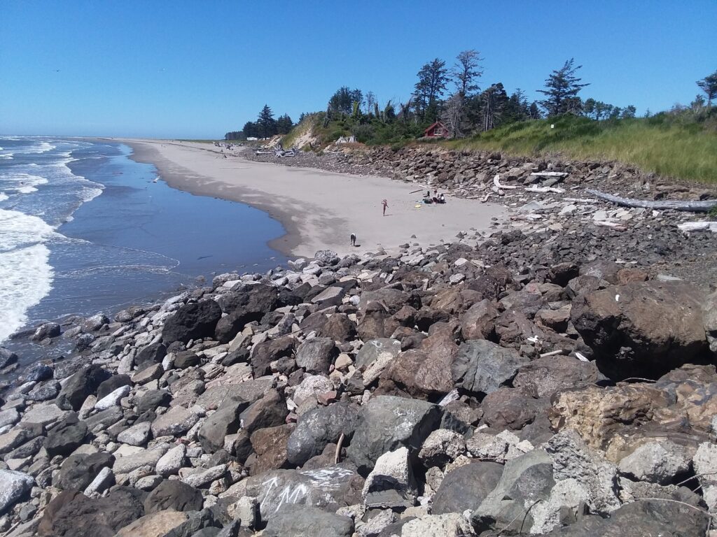 a rocky beach with people walking on it (MyCoast AI)