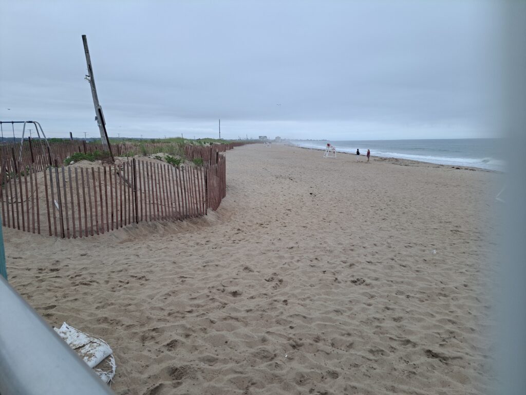 a sandy beach with a fence (MyCoast AI)