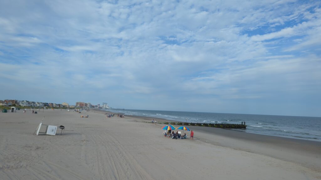 a beach with people and umbrellas (MyCoast AI)