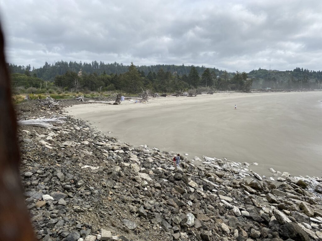 a rocky beach with people walking on it (MyCoast AI)