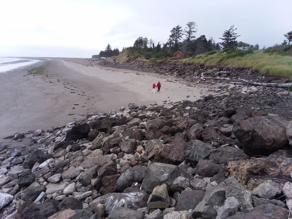 a couple people walking on a beach (MyCoast AI)