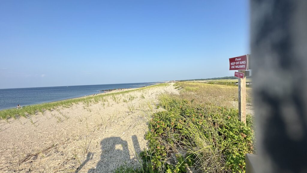 a sign on a beach (MyCoast AI)