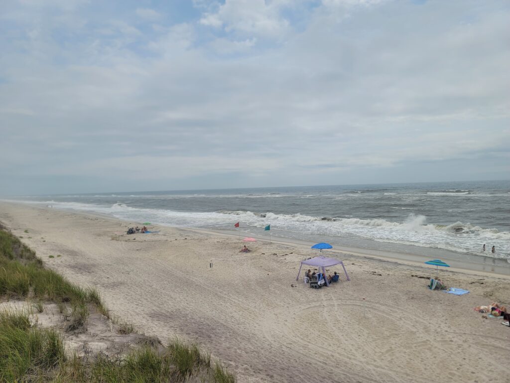 a beach with people and umbrellas (MyCoast AI)