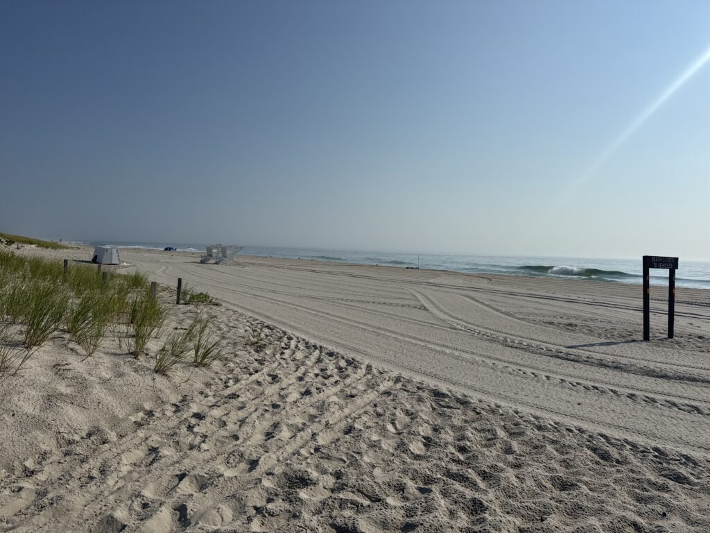 a sandy beach with a sign (MyCoast AI)