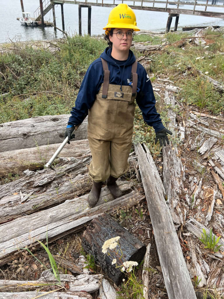 a man wearing a hard hat and standing on a log (MyCoast AI)