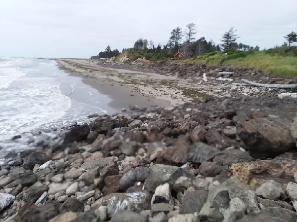 a rocky beach with a red house (MyCoast AI)