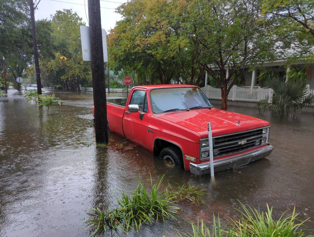 a red truck driving through a flooded street (MyCoast AI)
