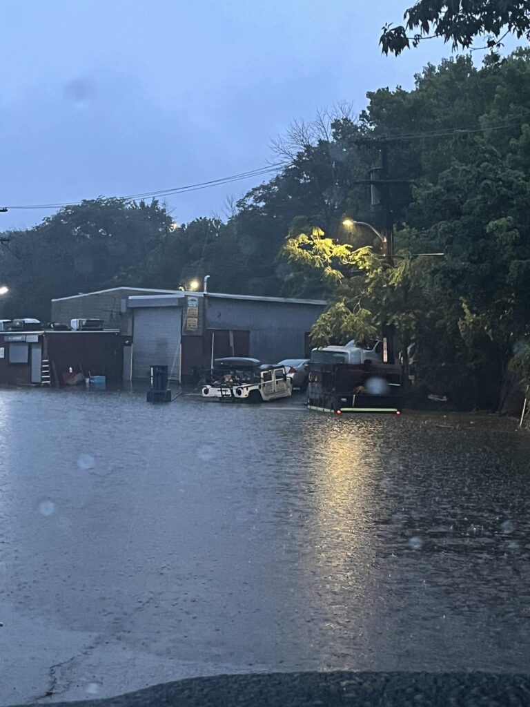 a flooded street with cars parked on the side (MyCoast AI)
