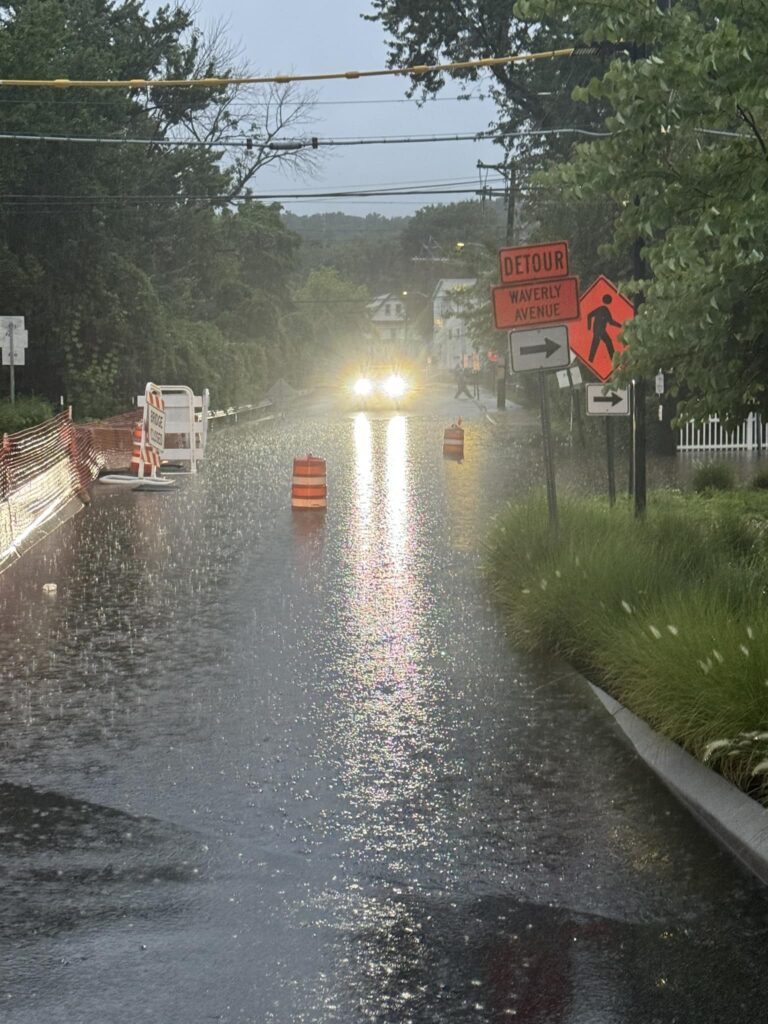 a flooded street with a car driving (MyCoast AI)